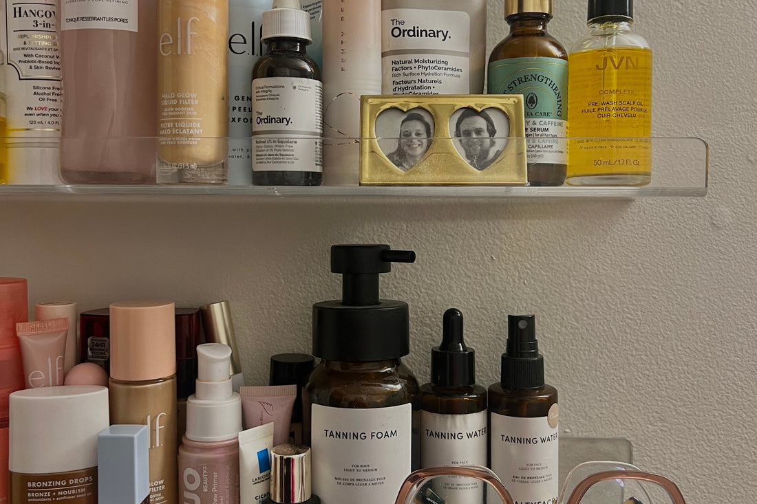 Someone with sensitive skin deciding whether to stop using irritating skincare products in her bathroom cabinet 