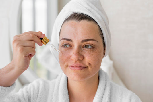 Woman checking facial lines before starting an anti-aging skincare routine.