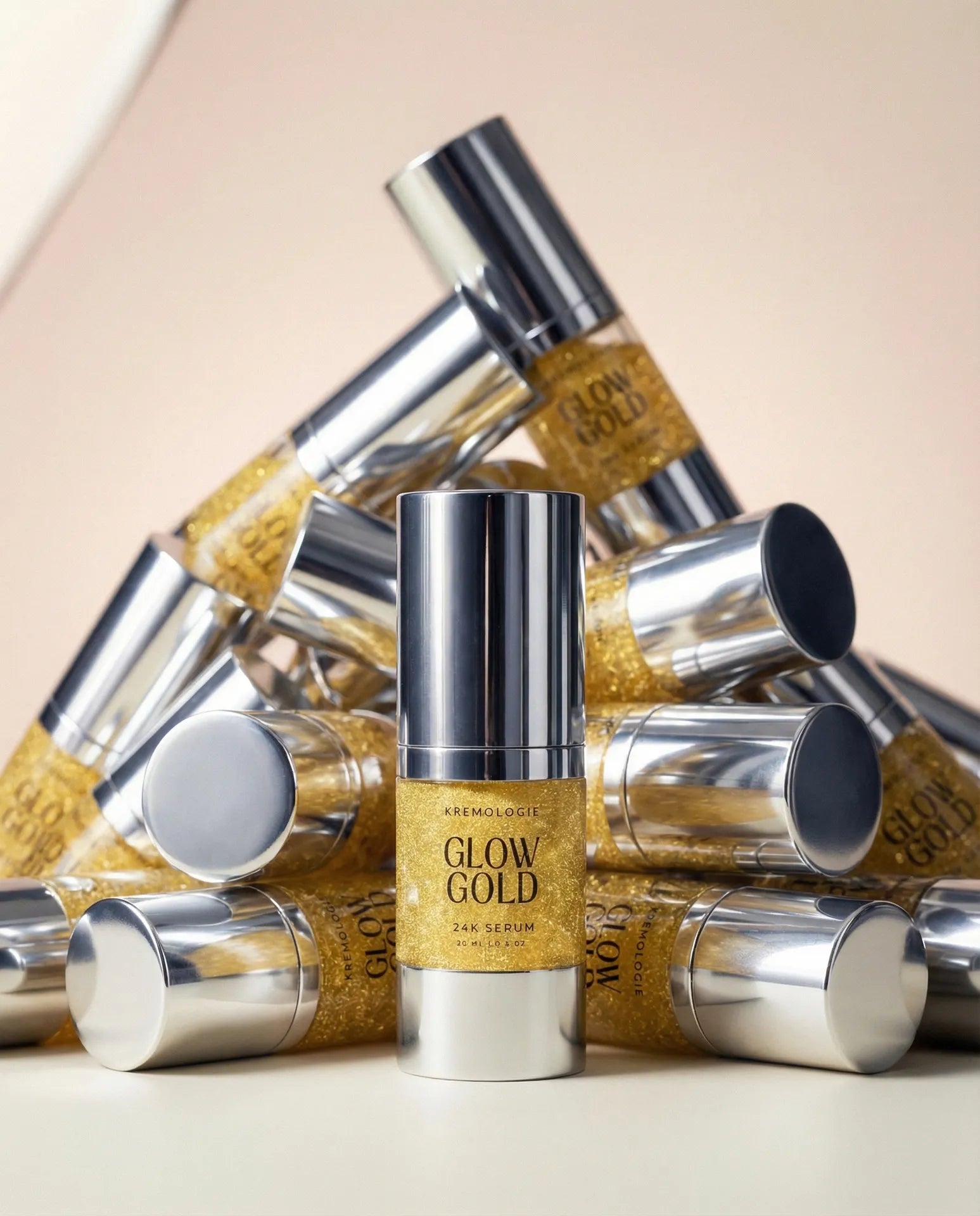 Kremologie Glow Gold skincare serum bottles on a beige background