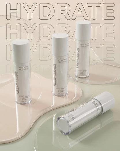 Skincare bottles with 'KREMOLOGIE Restorative Moisturizer' text on a beige background