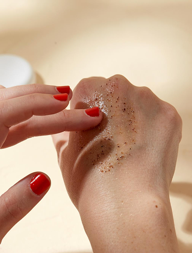 woman applying KREMOLOGIE BODY Scrub on her hand